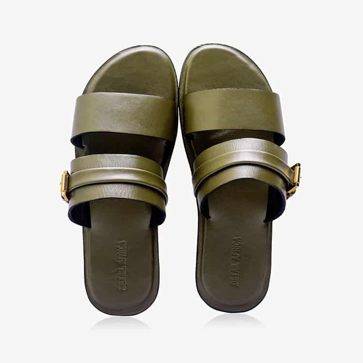 A pair of dark green Mechi Leather Slippers with double straps and gold-tone buckle details, shown from a top-down view 