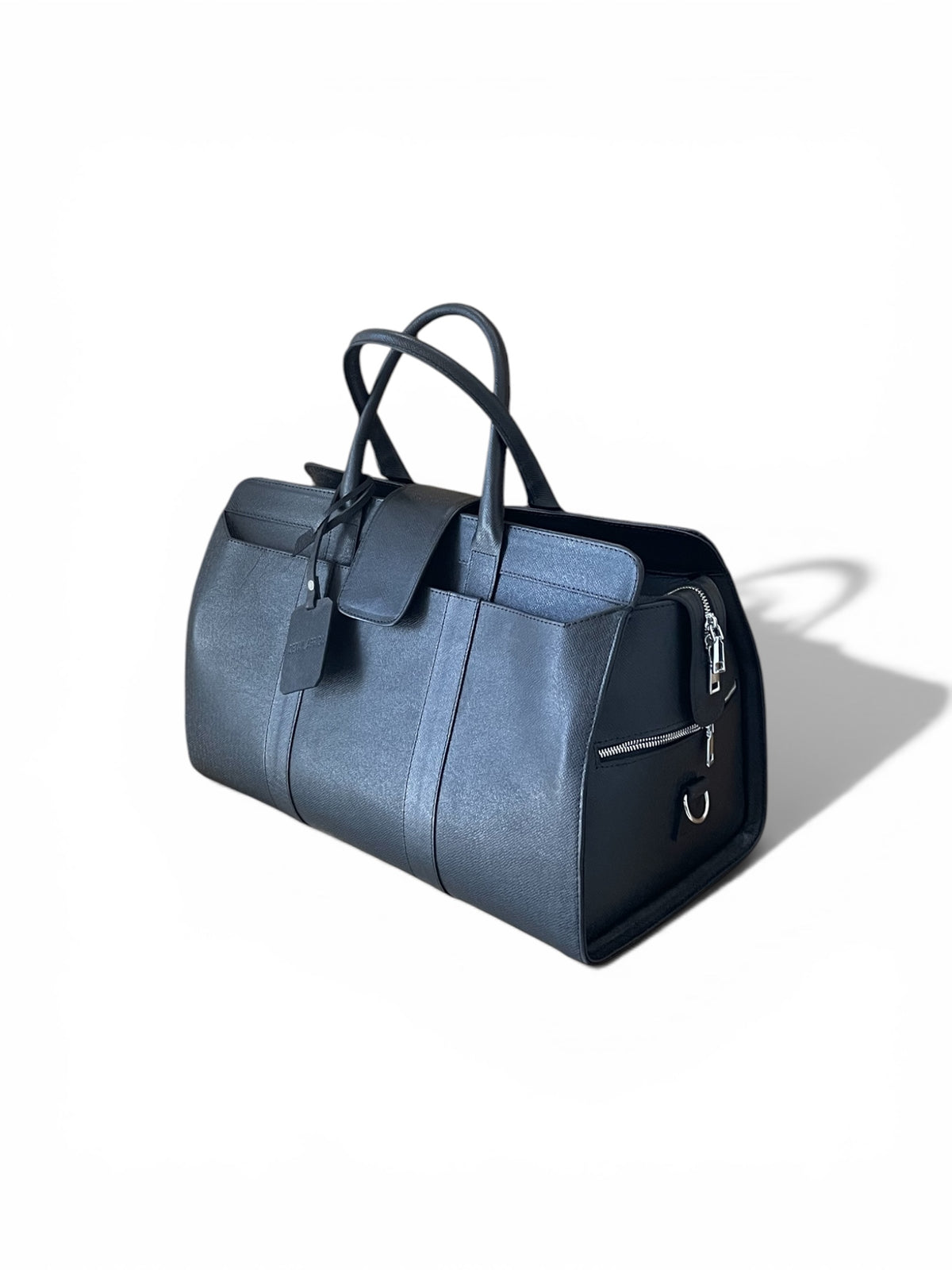  side view of the tourman leather duffel bag with black handles and a black front pocket